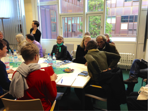 Participants of the workshop immersed in discussion in between presentations.